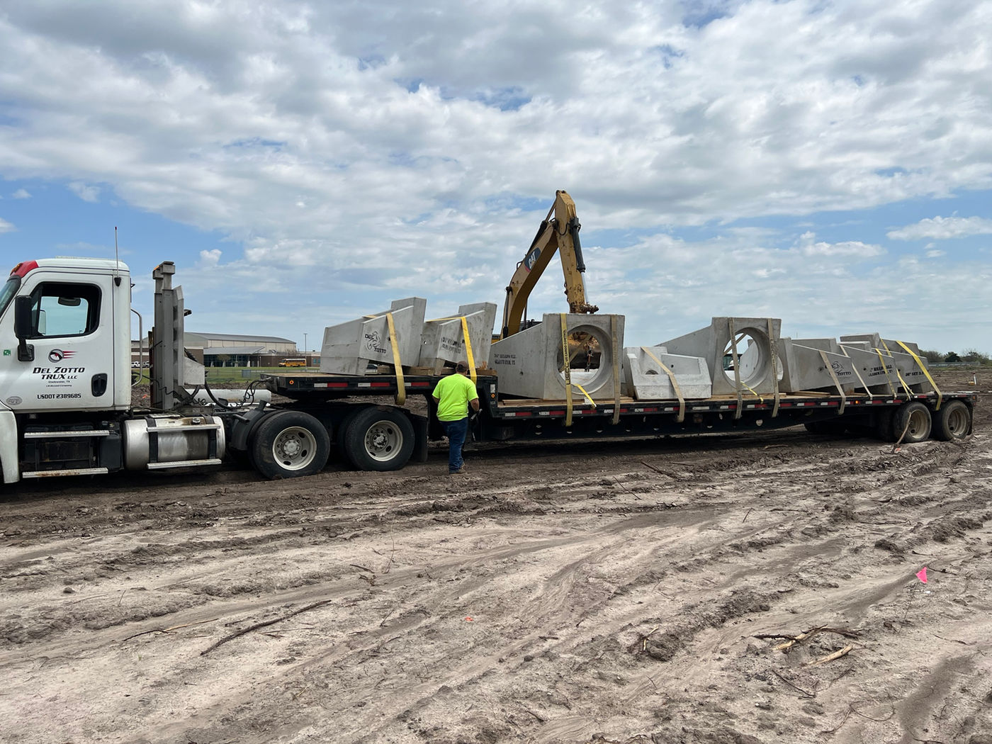Truck hauling precast structures at jobsite